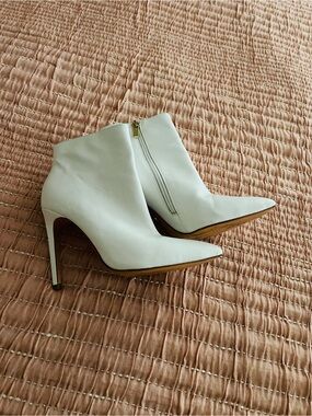 White stiletto ankle booties by Raye.